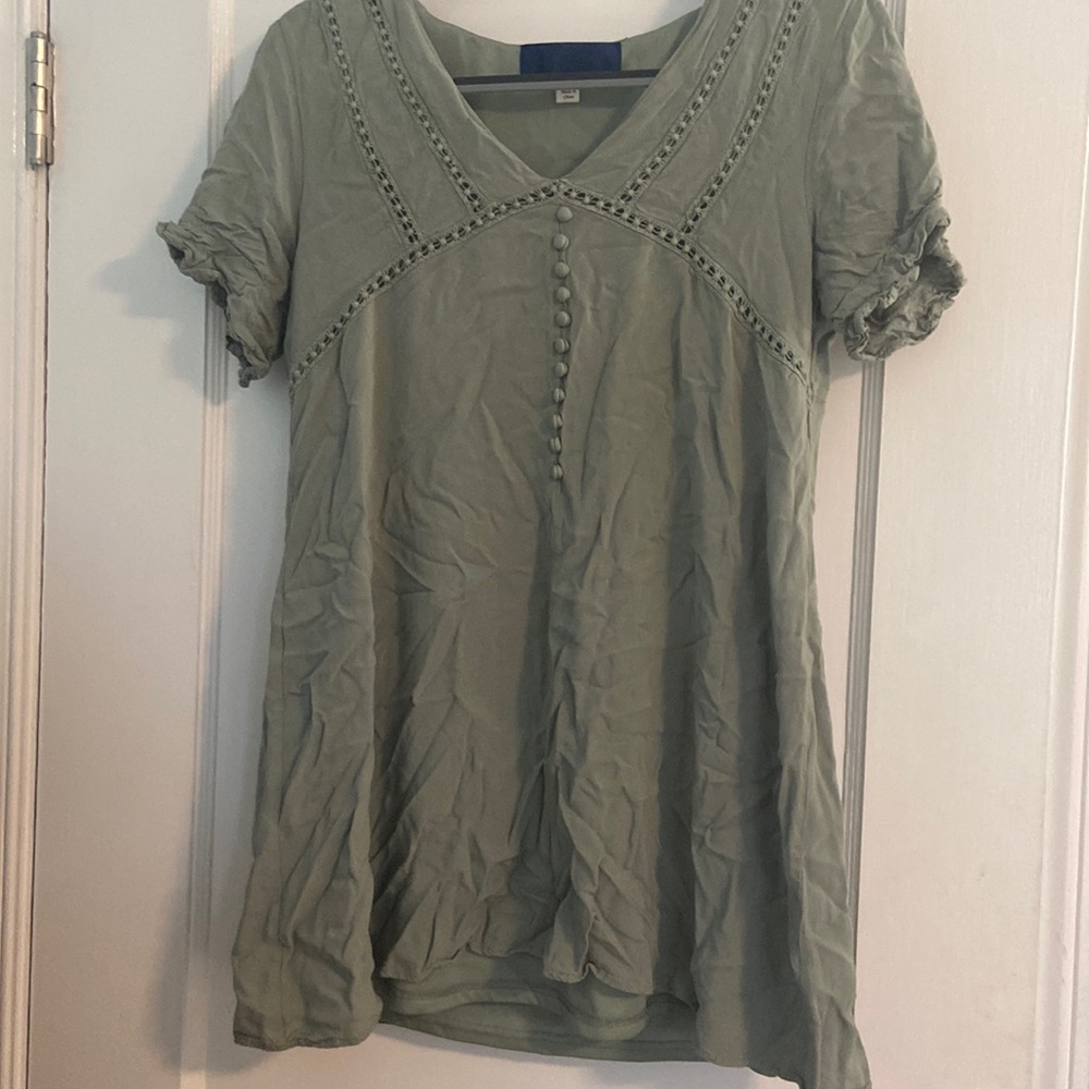 A small green sundress with buttons